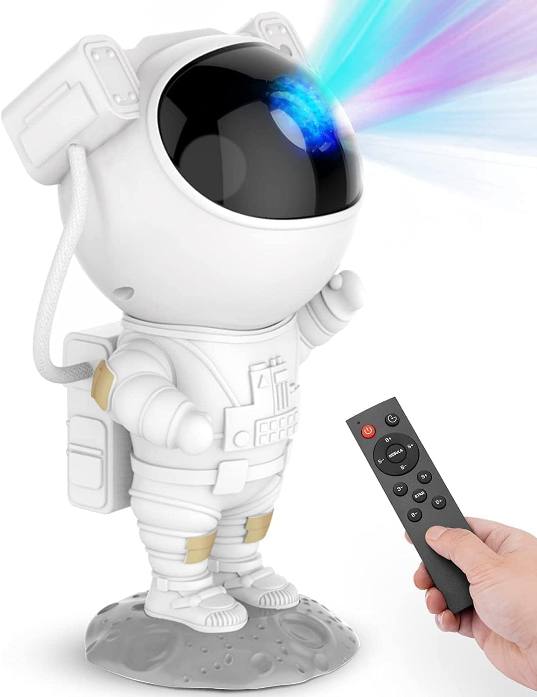 A toy astronaut holding an Indian flag stands on a rocky surface, evoking a lunar landscape. A remote control lies on the left, suggesting the use of a space projector. The bright, full moon in the background enhances this Astronaut Galaxy Projector-themed scene.