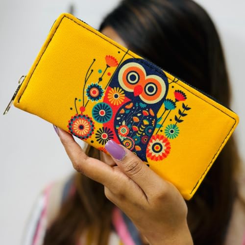 A woman displays a yellow canvas wallet featuring a cute owl design.