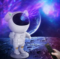 A person with a remote control sits beside a colorful space-themed toy, ready for an imaginative adventure.