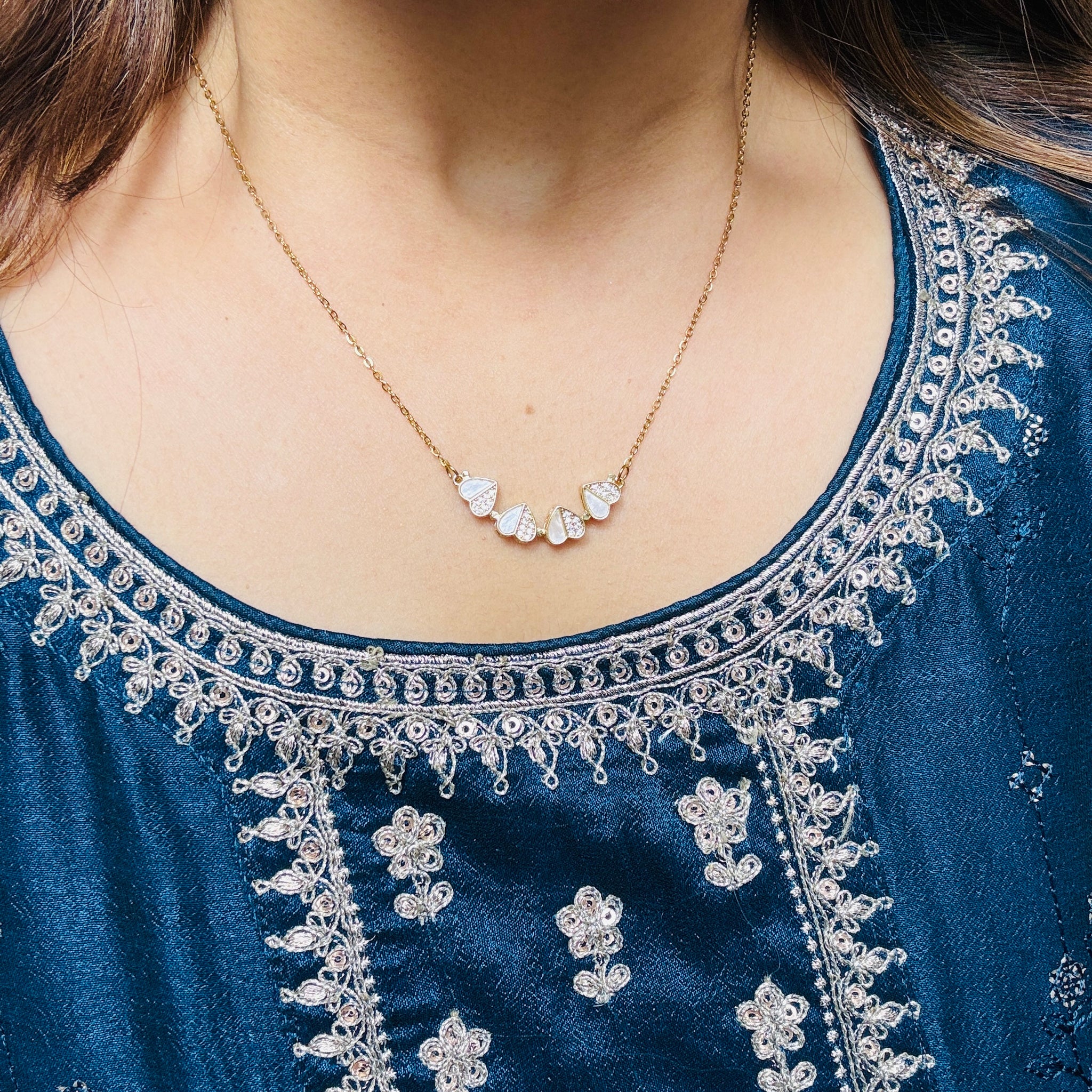 Model wearing heart pendant